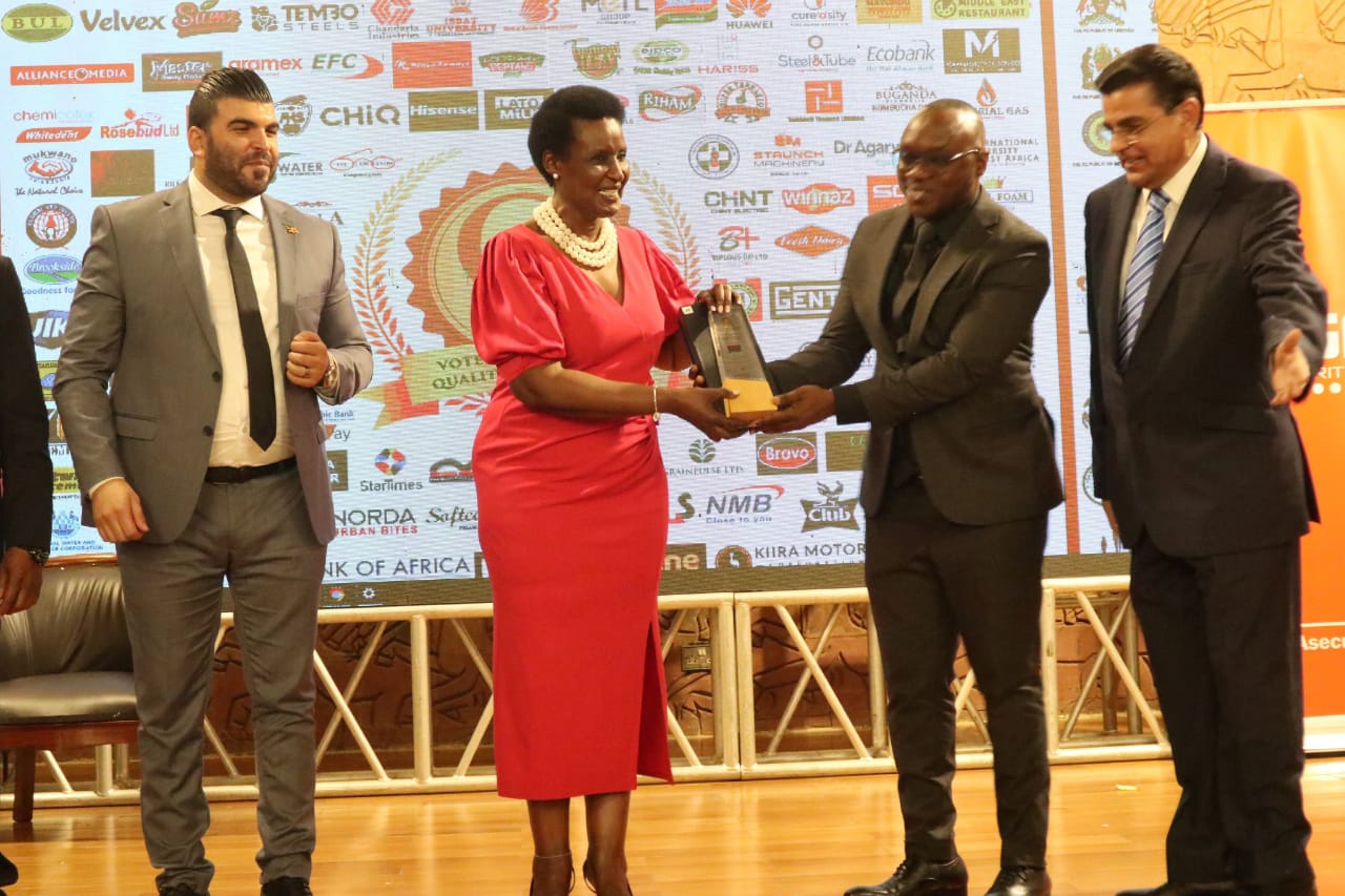 Hon. Amelia Kyambadde awarding Indomie Brand presented to Mr Kennedy Hon. Amelia Kyambadde awarding Indomie Brand presented to Mr Kennedy