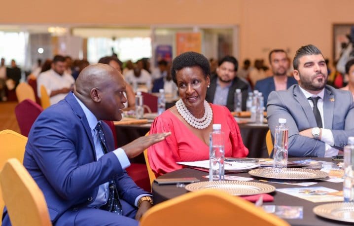 Hon. Amelia Kyambadde having a discussion with Mr. Otim Gilbert of Stabex International at the East Africa Brand Quality Awards gala Hon. Amelia Kyambadde having a discussion with Mr. Otim Gilbert of Stabex International at the East Africa Brand Quality Awards gala