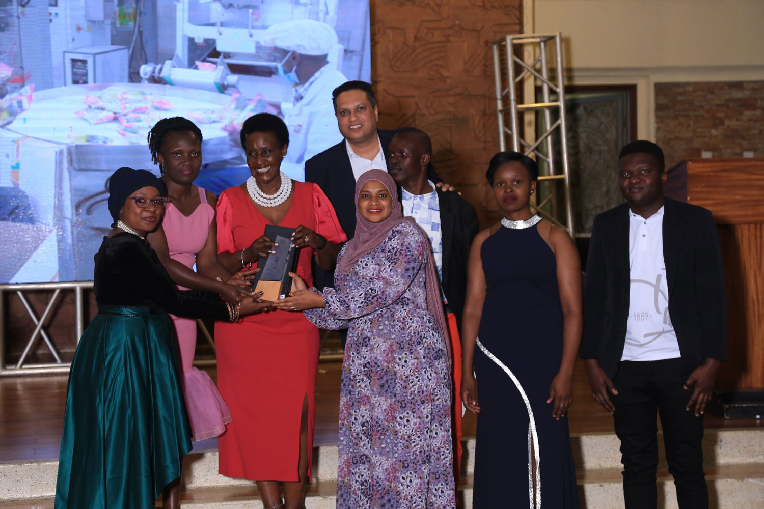 Tropical Heat Group team led by Ms. Sarah receiving the East Africa Brand Quality Awards from Hon. Amelia Kyambadde Tropical Heat Group team led by Ms. Sarah receiving the East Africa Brand Quality Awards from Hon. Amelia Kyambadde